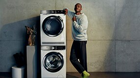 Man standing next to washing machines